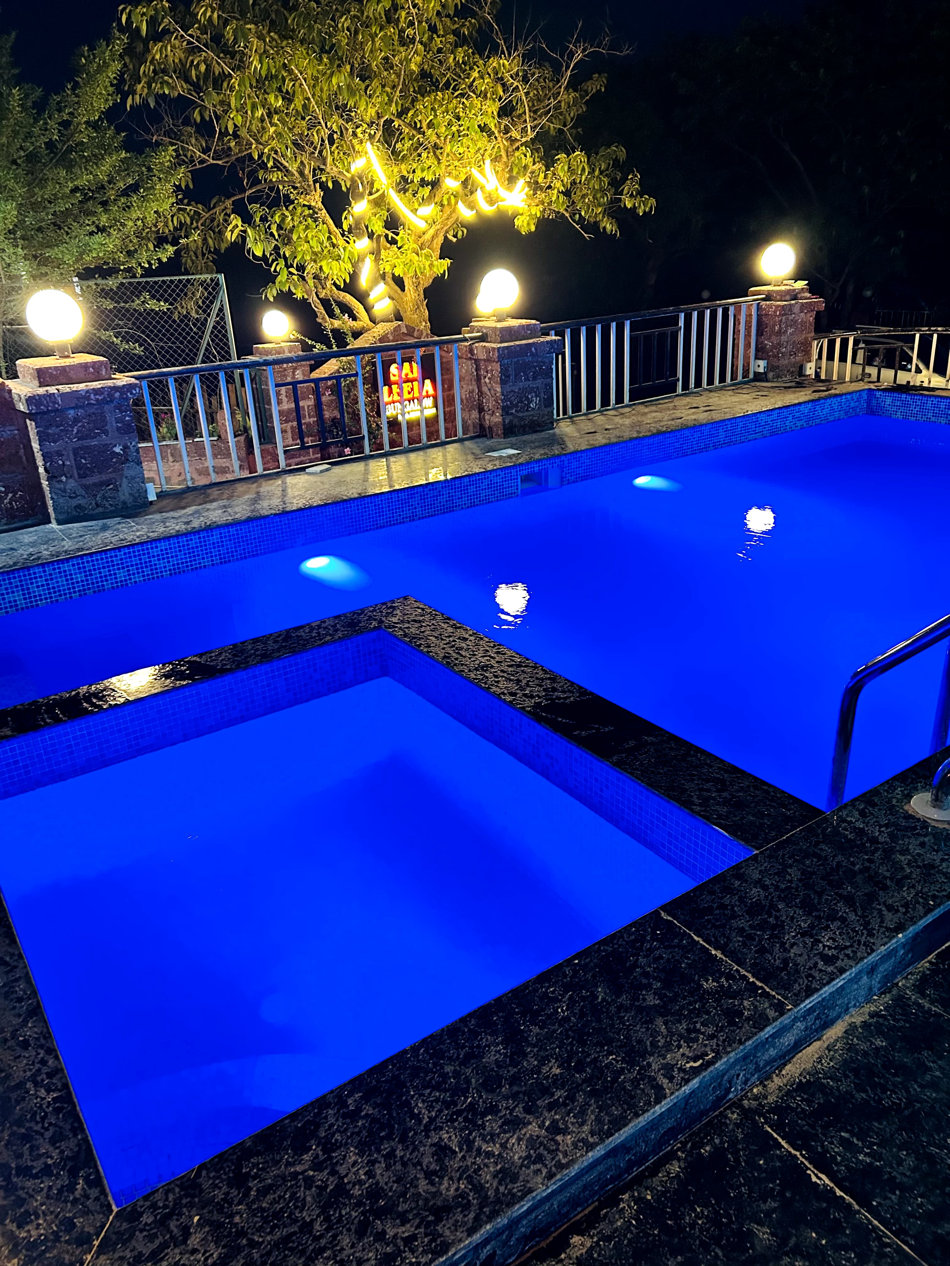 Private pool lit in blue at night